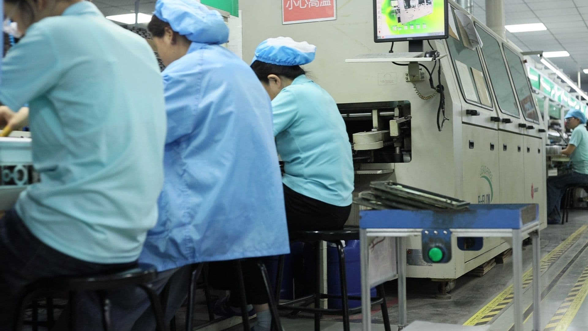 An AGV transporting fixtures inside the through‑hole PCB assembly line
